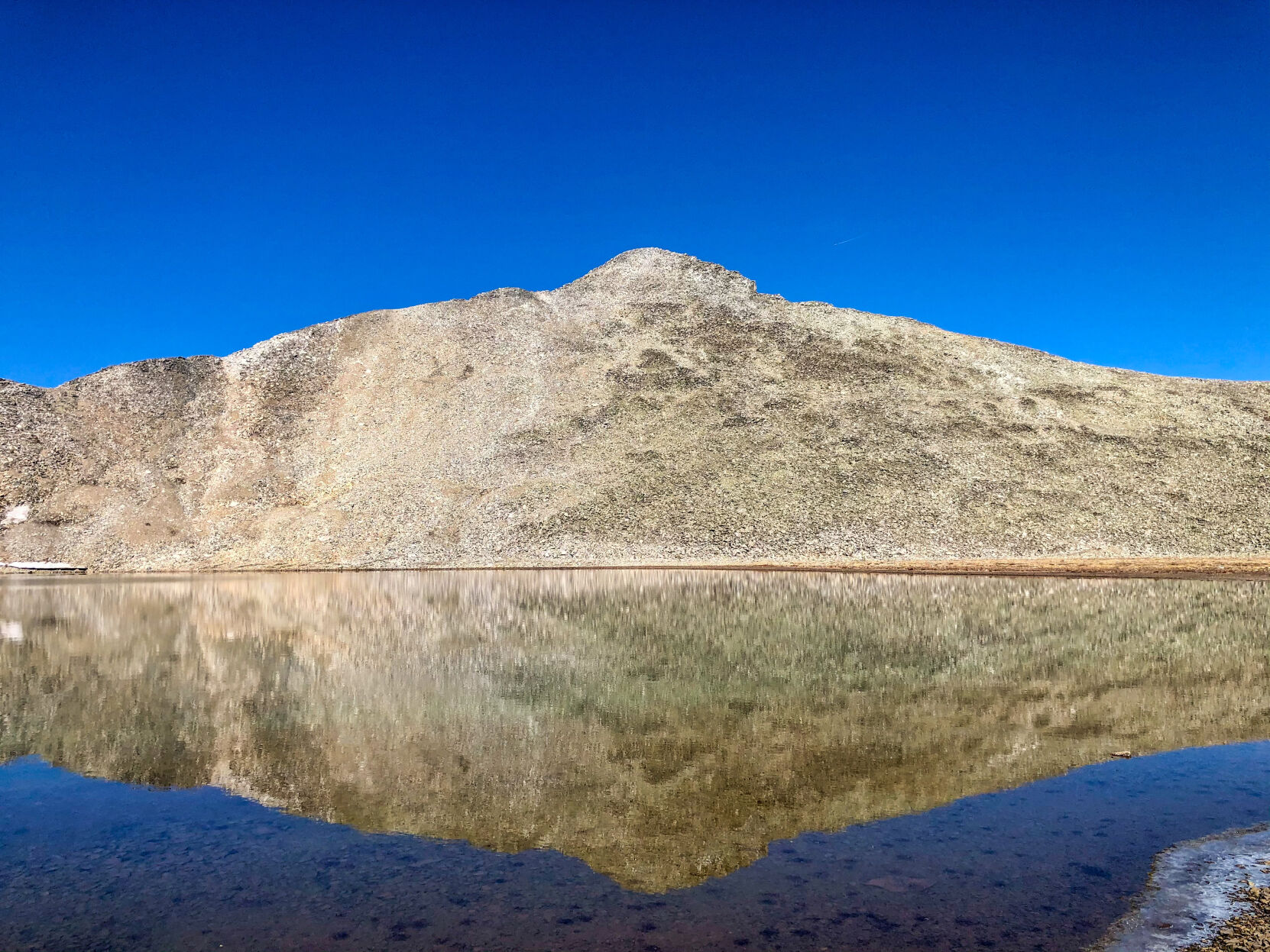 A nearby peak reflects in America's highest alpine lake. Photo Credit: Spencer McKee